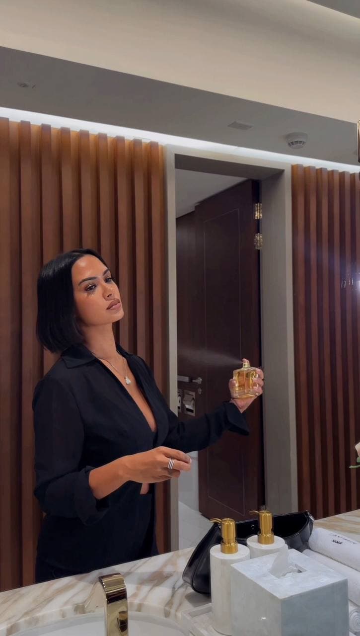 woman spraying perfume